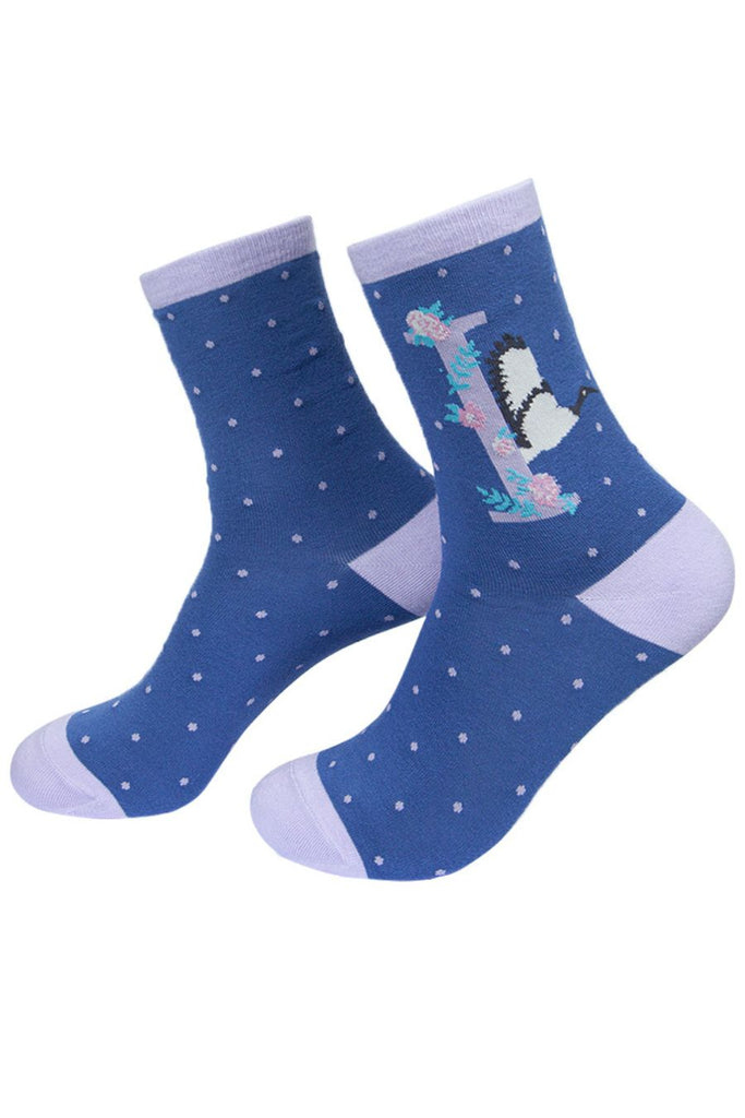 blue socks with a large letter i, an ibis bird and a floral pattern on the ankle