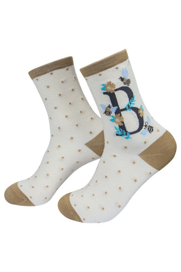 cream and gold socks with a large letter b, honey bees and a floral pattern on the ankle