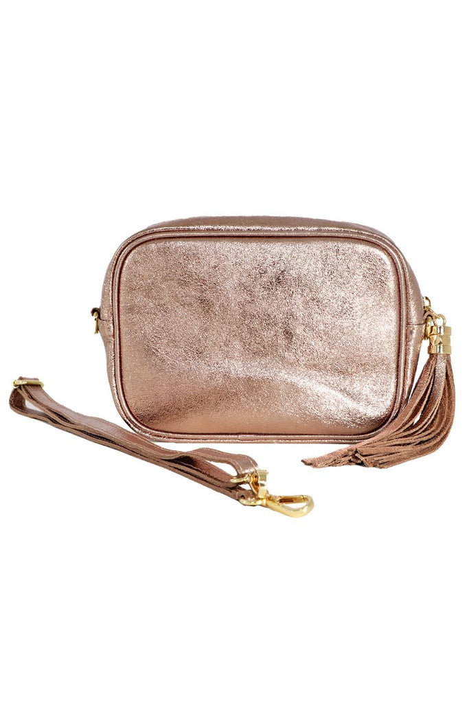 champagne coloured metallic leather crossbody camera bag with a detachable adjustable bag strap