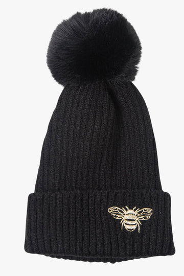 black winter pom pom hat with an embroided bee motif