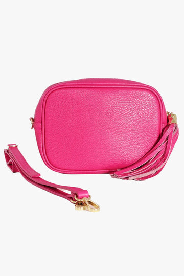 vibrant pink leather crossbody camera bag with matching detachable bag strap