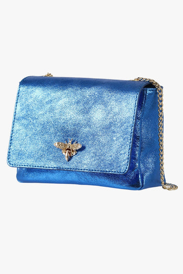 metallic blue leather crossbody bag with a gold chain strap and a gold bee clasp on the front