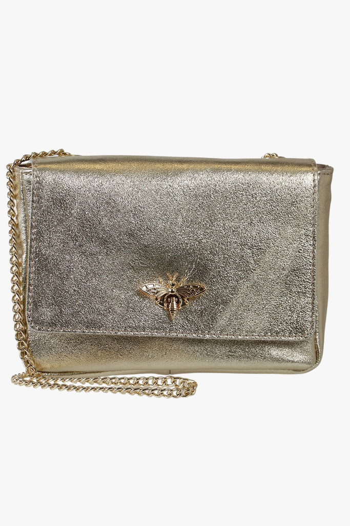 gold leather crossbody bag with a gold chain strap and a gold bee clasp on the front