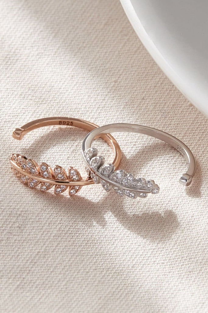 close up of both the silver and rose gold plated sterling silver cz open leaf rings, S925 hallmark is visible on the inside rim of the rings