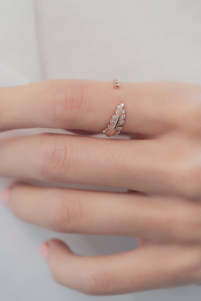 showing the rose gold open ring being worn on an index finger, highlighting the open design 