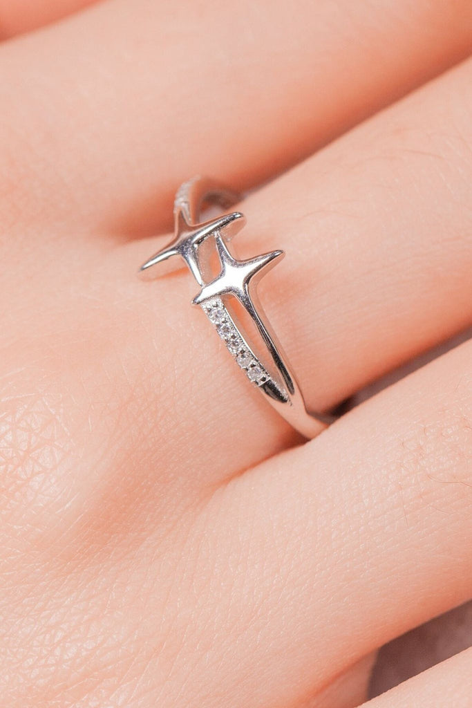 sterling silver ring featuring two stars and clear cz crystal accents on the band