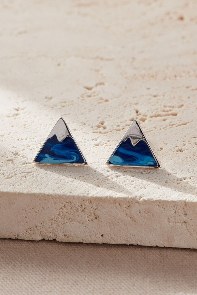 showing the front of the earrings with the snow capped mountain effect, the top of the mountain in silver coloured and the rest if it is blue
