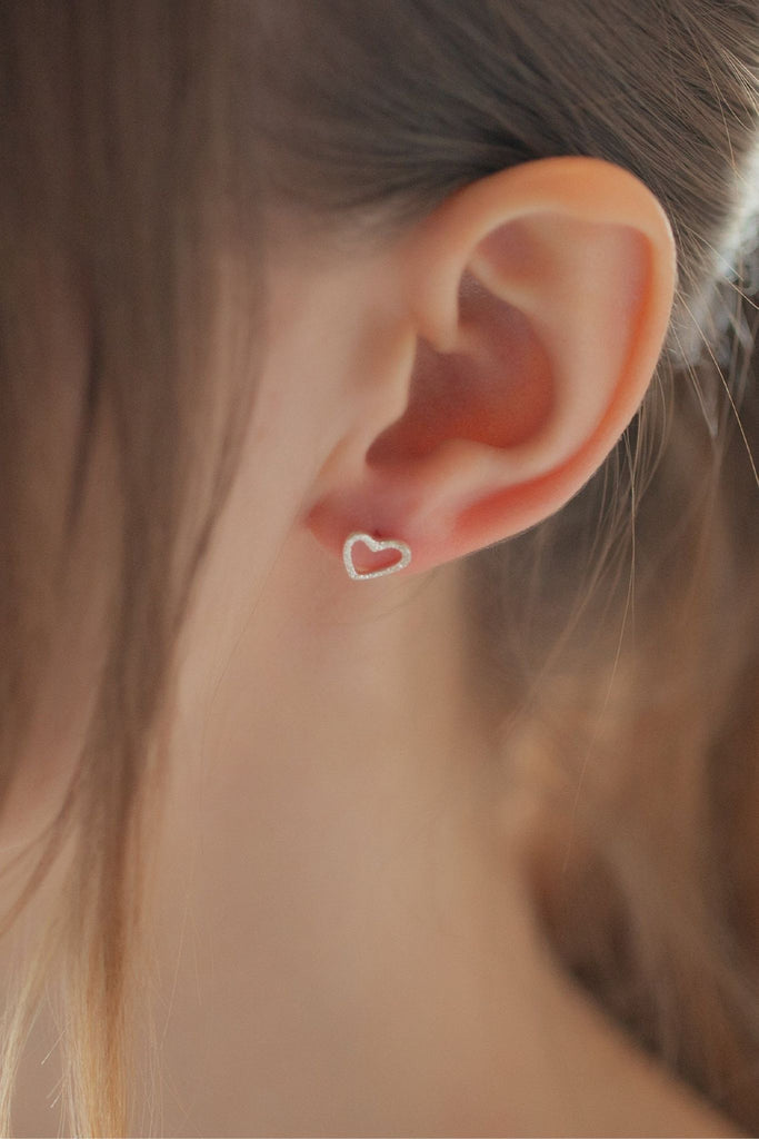 showing the earring being worn in the earlobe