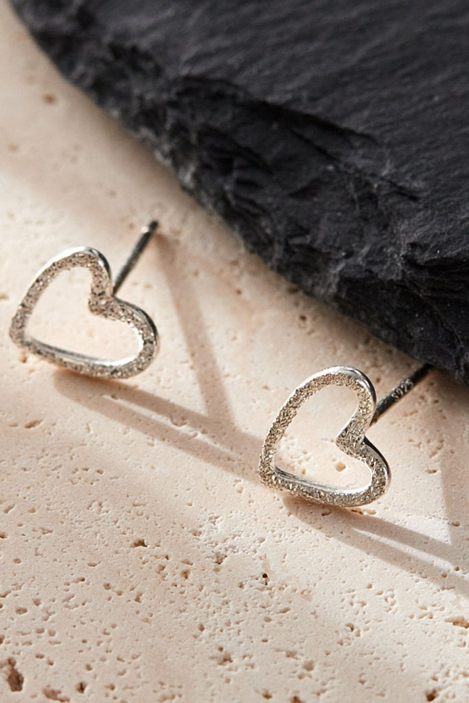 close up of the open heart silver earrings, showing the S925 sterling silver stamp