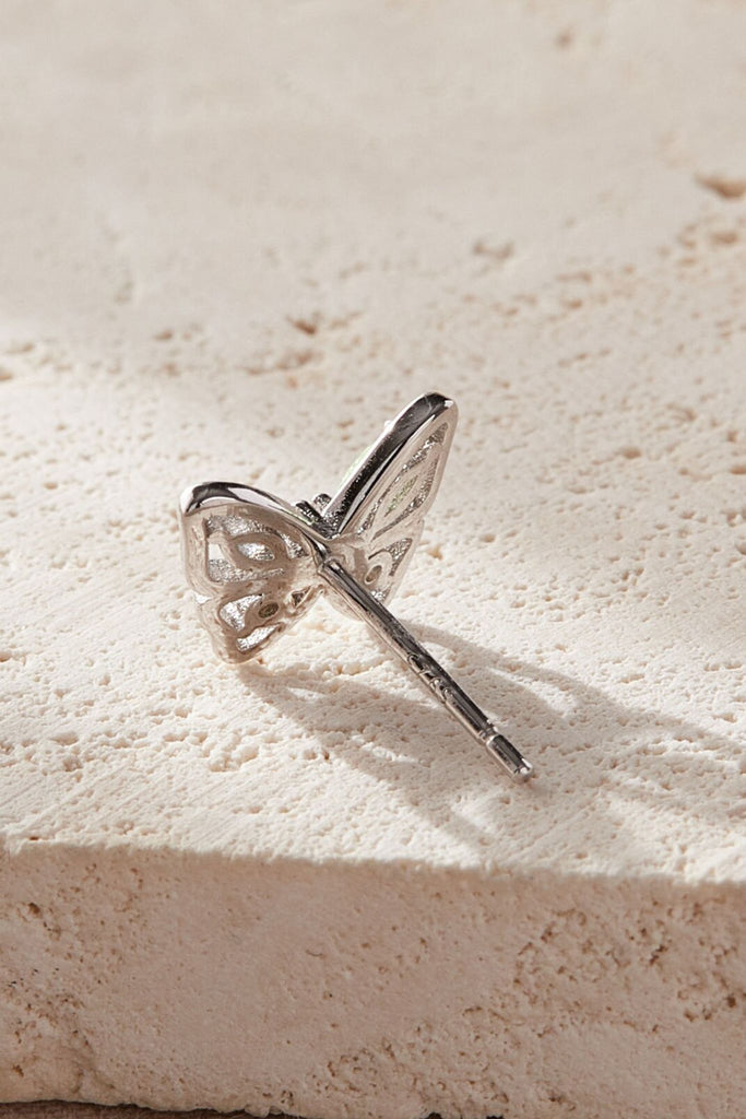 showing the silver underside of the earrings