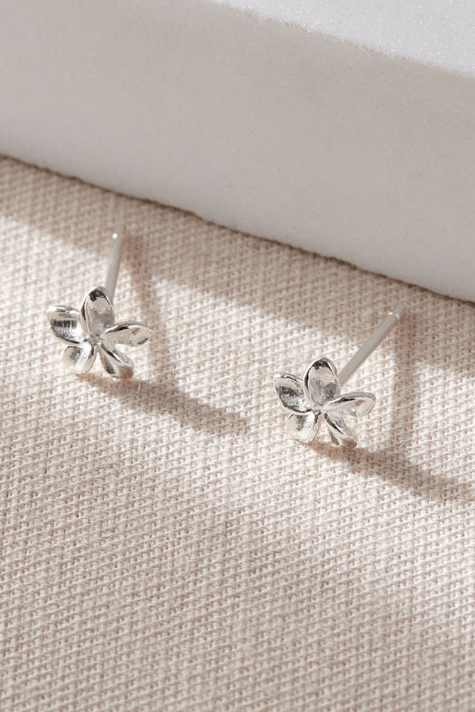 a pair of sterling silver flower stud earrings, a five petal floral design