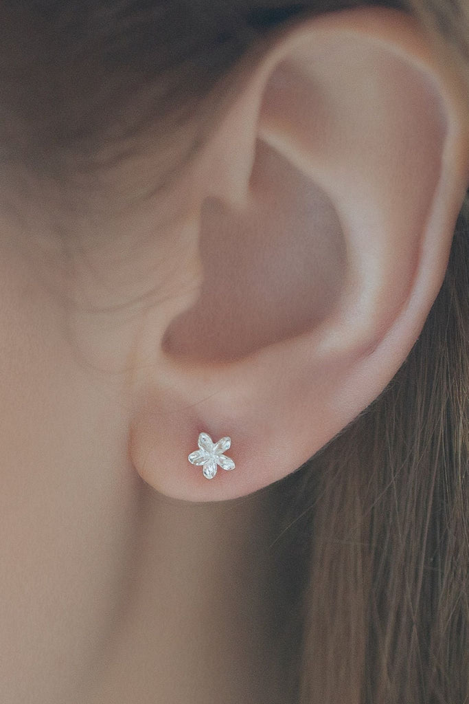 showing the dainty studs being worn on an earlobe