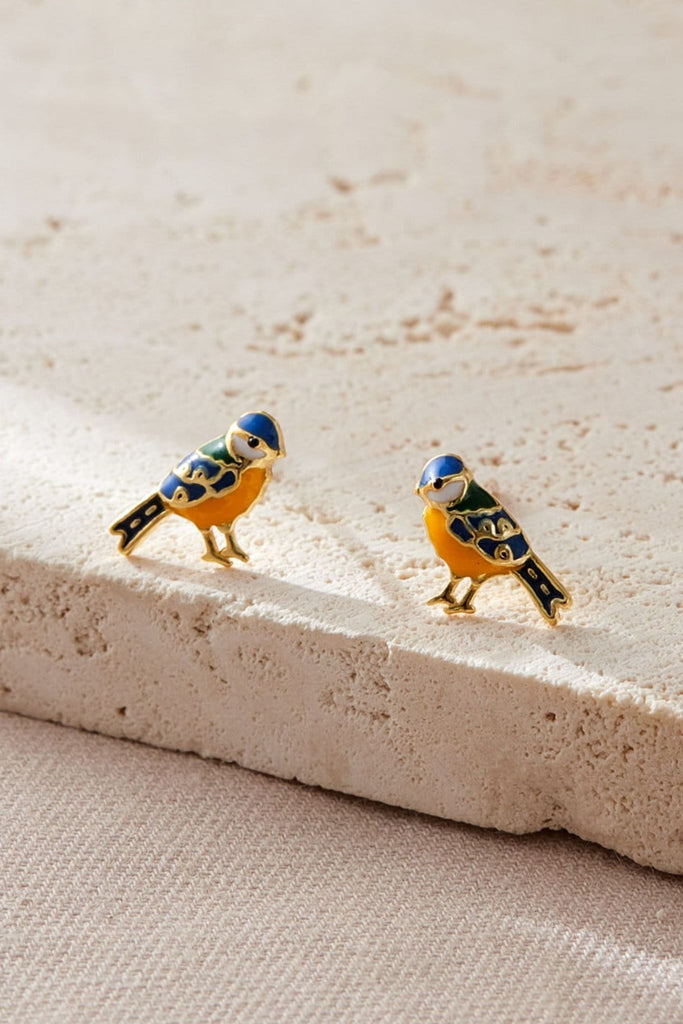 close up of the gold blue tit earrings, showing the design details