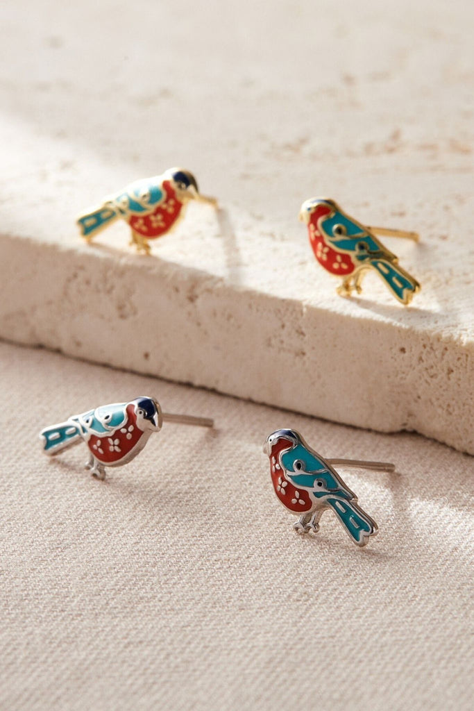 showing the two colour options, silver and plated gold bird stud earrings