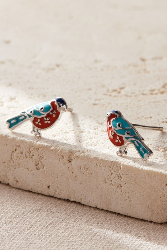 close up of the silver bullfinch stud earrings, showing the detailed design