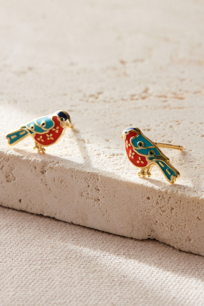 close up of the gold bullfinch stud earrings, showing the intricate design of the earrings