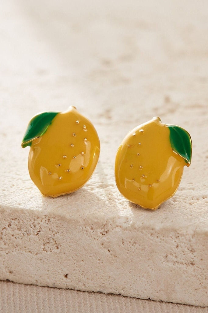 close up of the gold lemon stud earrings, showing the desing details