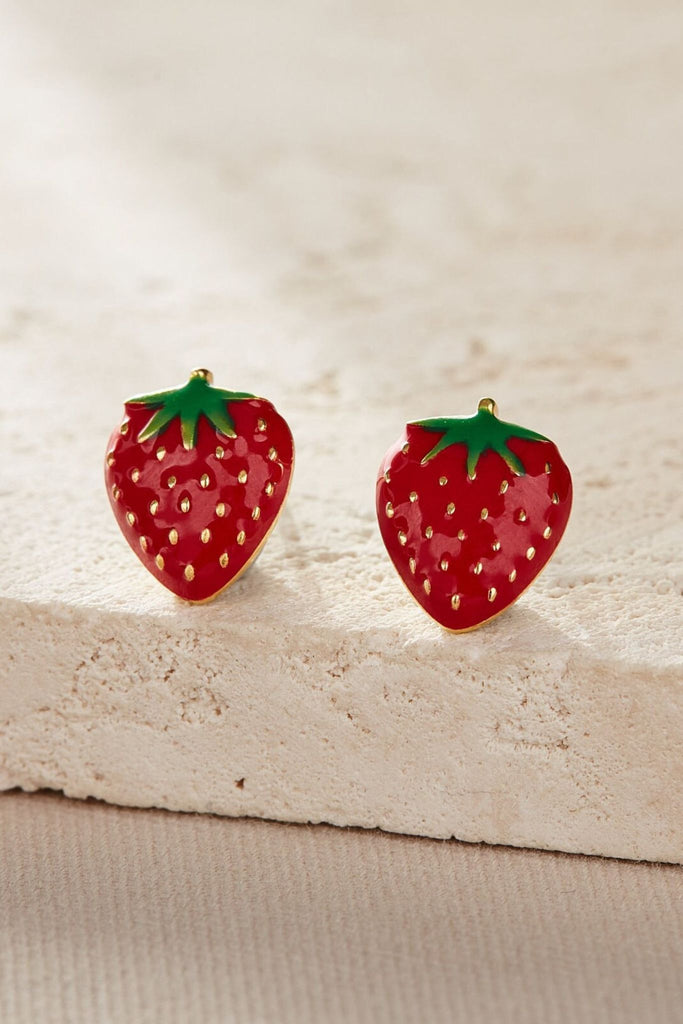 close up of the gold strawberry stud earrings, showing the design details