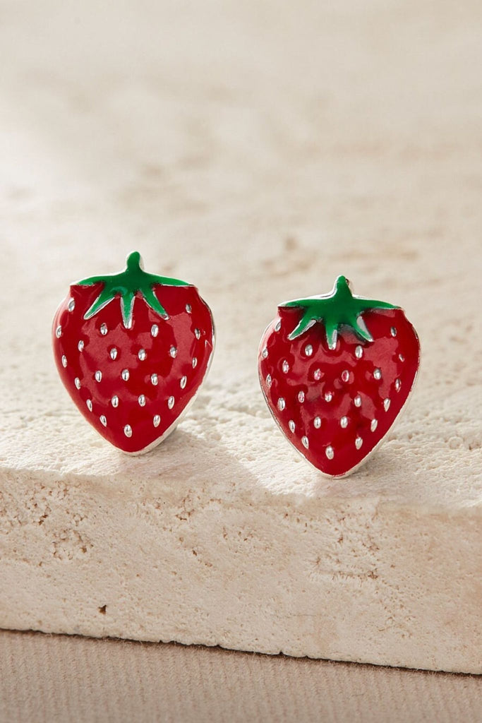 close up of the silver strawberry stud earrings, showing the design details