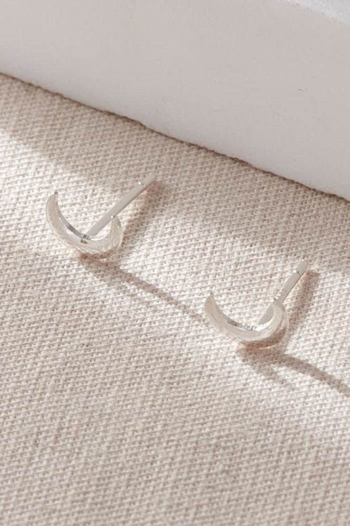 close up of the silver crescent moon dainty stud earrrings