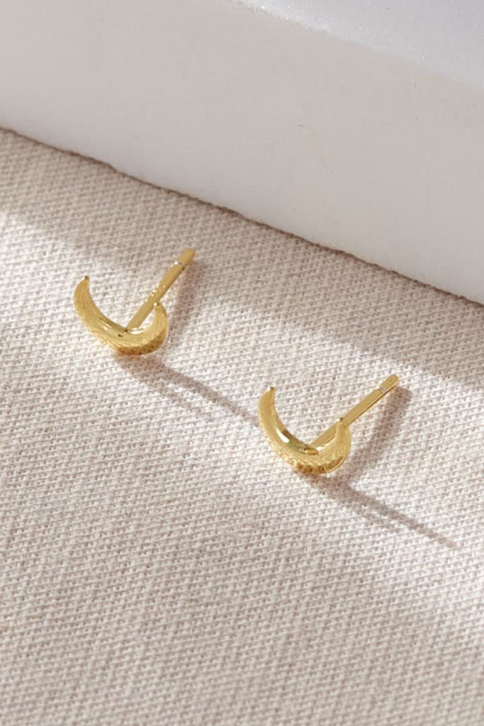 close up of the gold crescent moon dainty stud earrrings