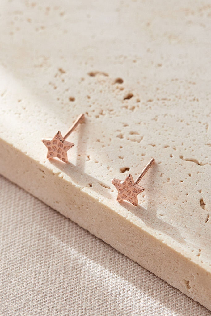 close up of the rose gold hammered star stud earrings