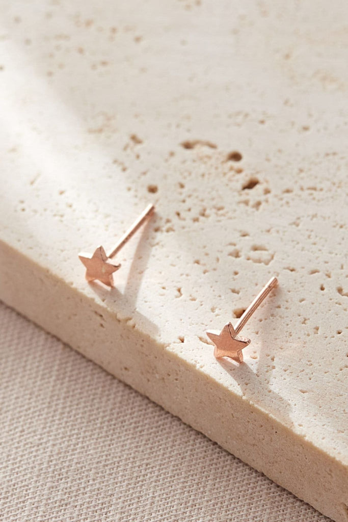 close up of the rose gold minimalist star stud earrings
