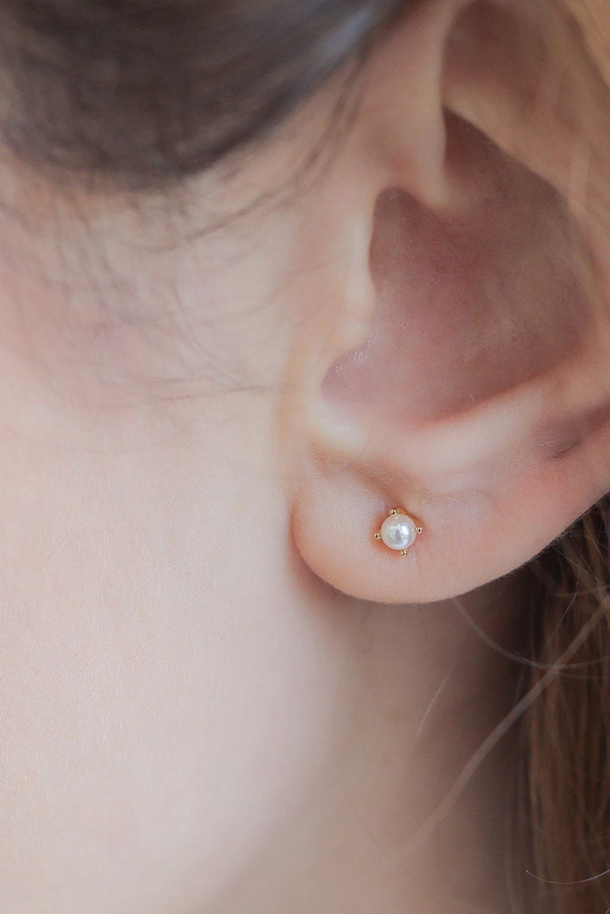 showing the faux pearl sterling silver stud earring being worn on the earlobe