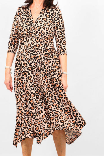 model wearing a neutral leopard print dress with 3/4 sleeves and a twist knot front