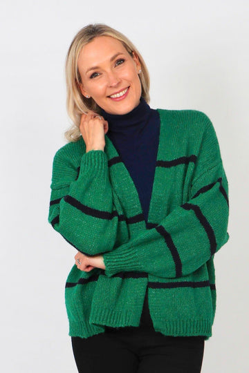 model wearing a green knit cardigan with a thin navy blue stripe throughout