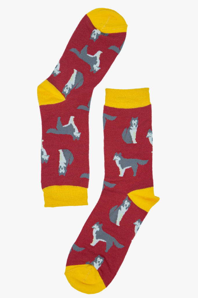 red and yellow bamboo socks with an all over pattern of husky dogs