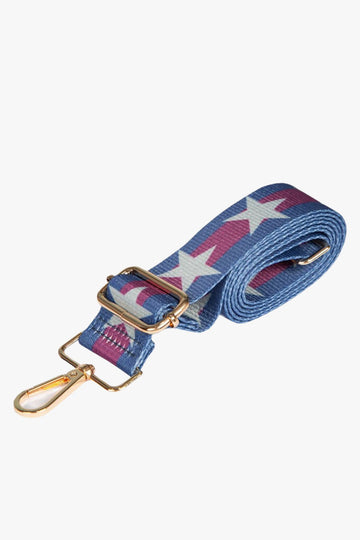 blue and pink striped bag strap with a white star pattern down the middle, gold hardware