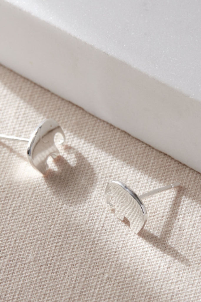 close up of the silver elephant earrings