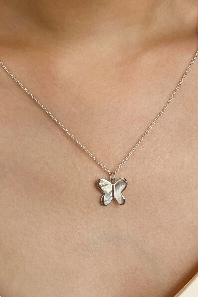 s925 butterfly pendant necklace being worn by a model around the neck