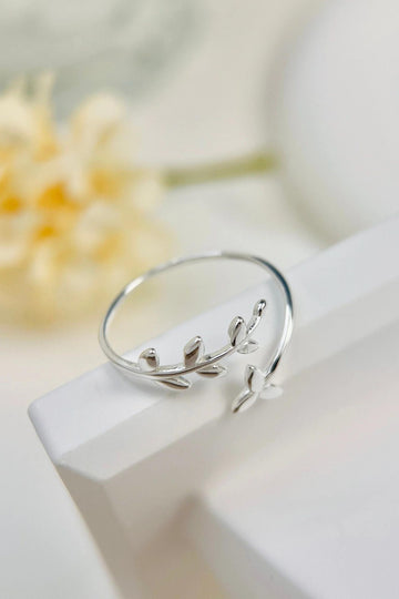 sterling silver open ring designed to look like an olive leaf, the design in asymmetrical 