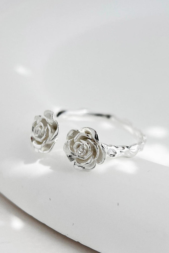 sterling silver open ring featuring two ornate roses on each end of the ring