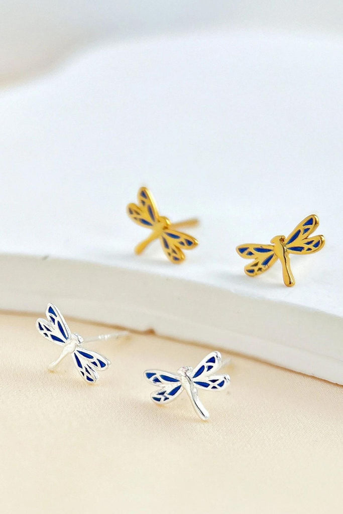 silver and gold dragonfly stud earrings with blue resin details on the wings