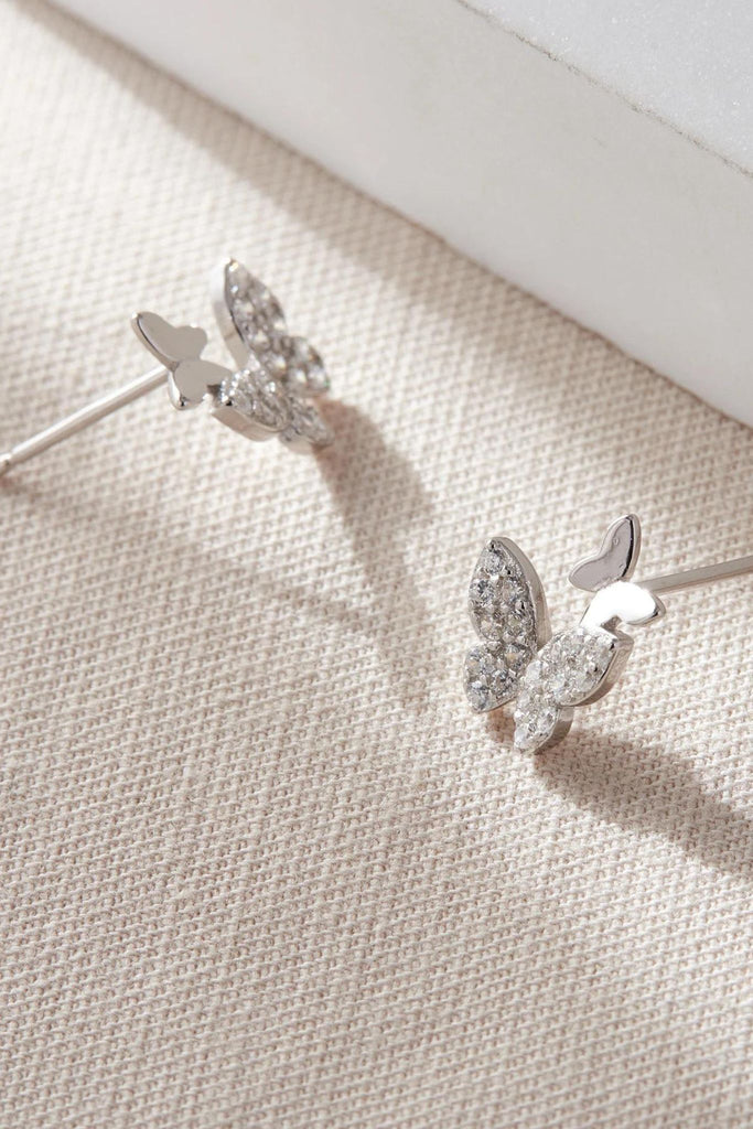 close up of the silver coloured butterfly stud earrings