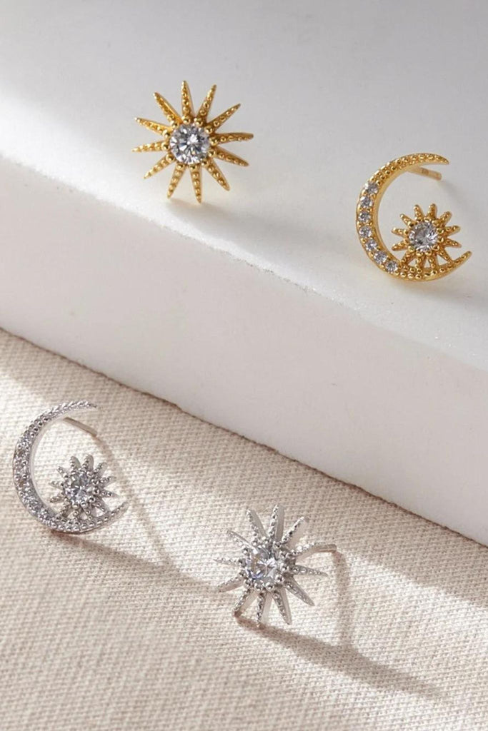 silver and gold plated sterling silver asymmetric celestial stud earrings, a star and moon encrusted with clear sparkly cz stones