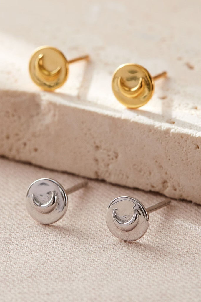 round stud earrings with raised crescent moon shapes in the middle