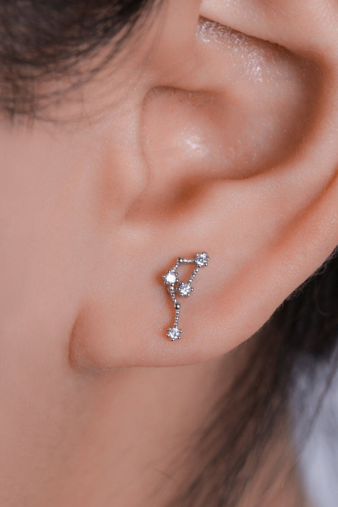 model wearing a zodiac constellation stud earring 