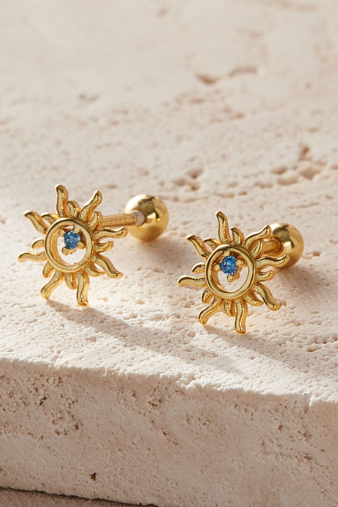 close up of the gold plated silver sun cartilage stud earrings, showing the ball back fastenings