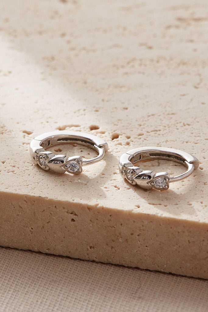 close up of the heart shaped clear white cz crystals embedded in the hoops