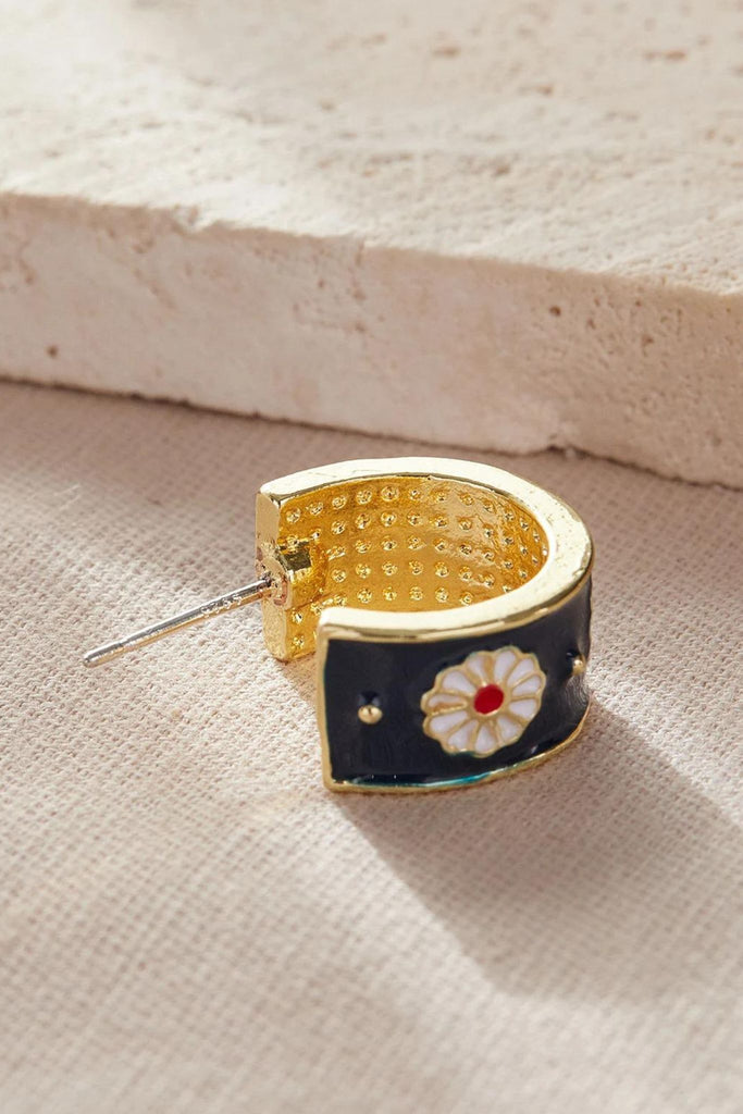 showing the sterling silver pin on these copper and enamel half hoop earrings