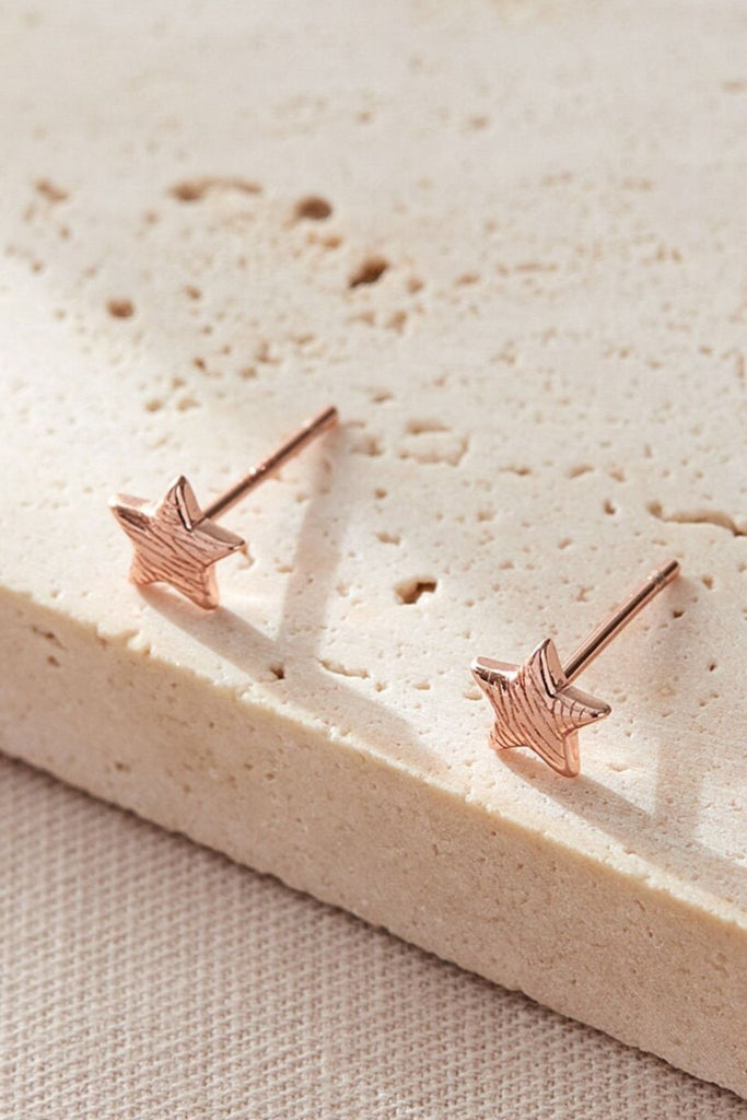 close up of the rose gold coloured s925 coloured zebra print star stud earrings