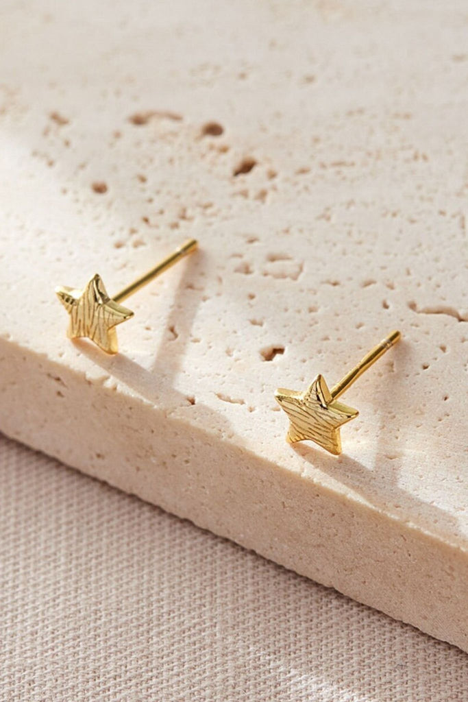 close up of the gold coloured s925 coloured zebra print star stud earrings