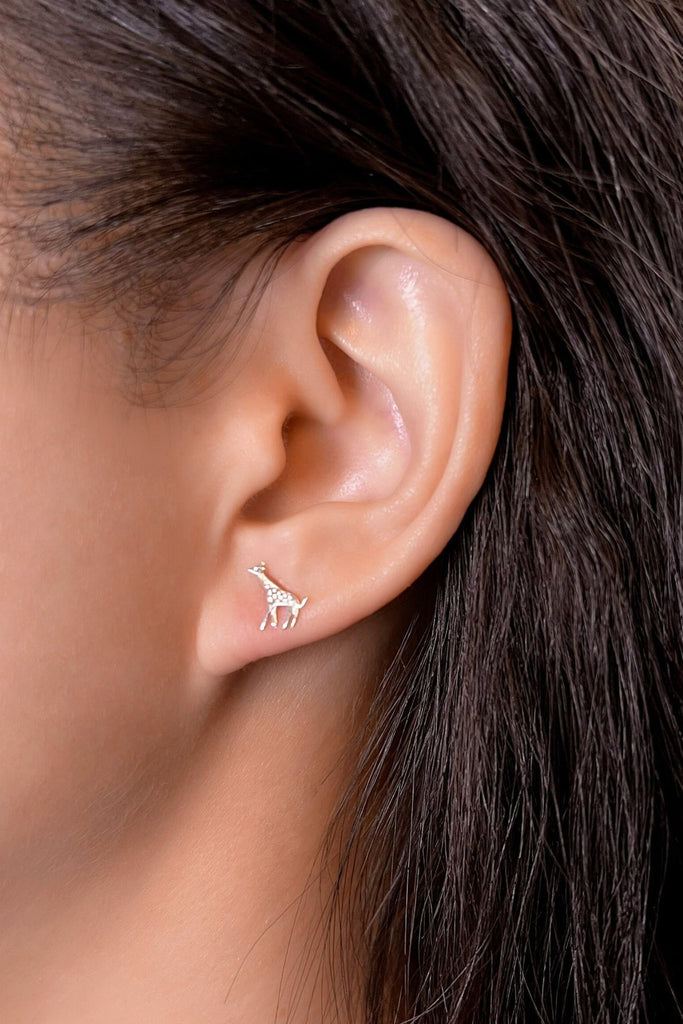 model wearing the silver giraffe stud earrings in the earlobe