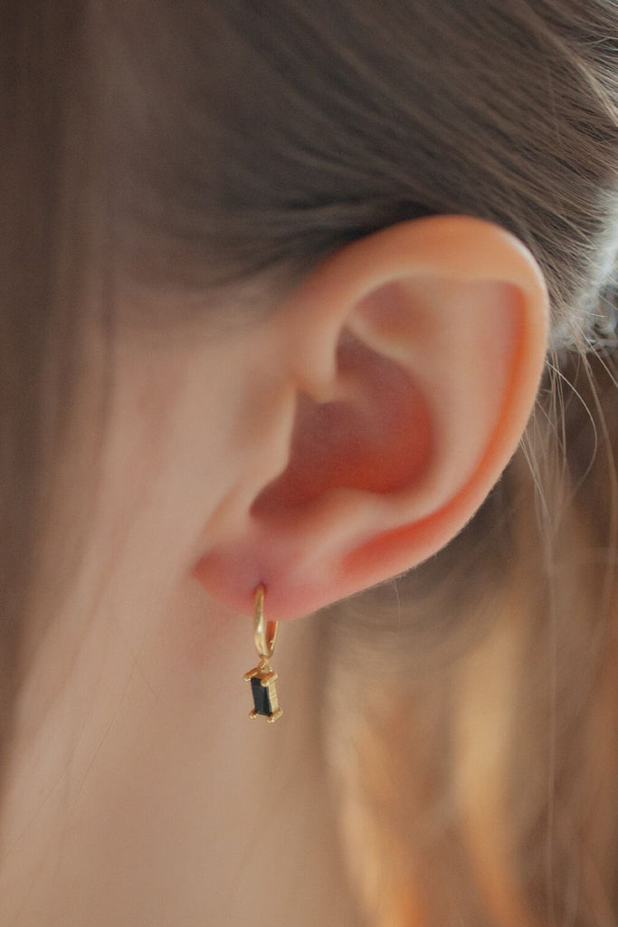 close up of the black cz gold dangle hoop earrings