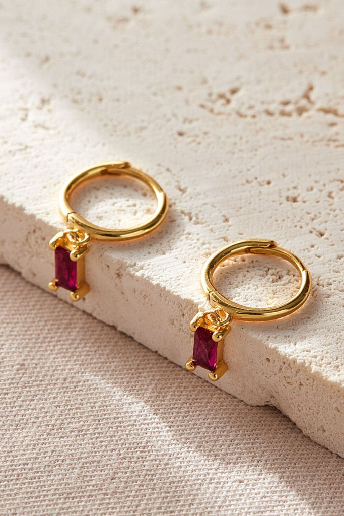 close up of the pink cz gold dangle hoop earrings