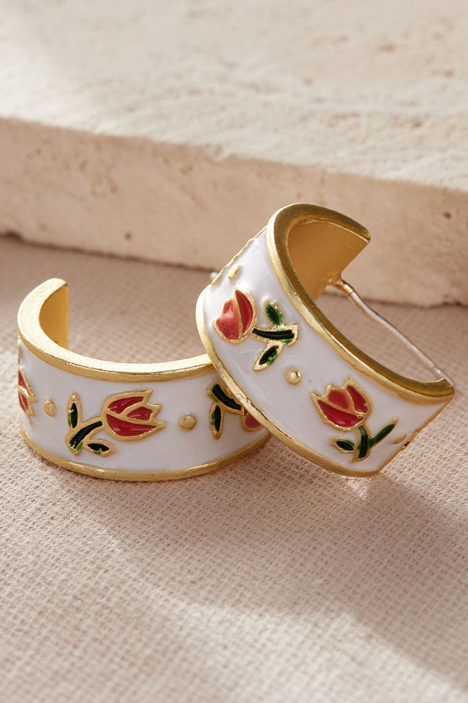 white and gold coloured half hoop earrings with pink tulip flowers on them